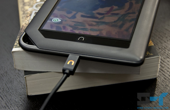 B&N Nook Color charging on a stack of books