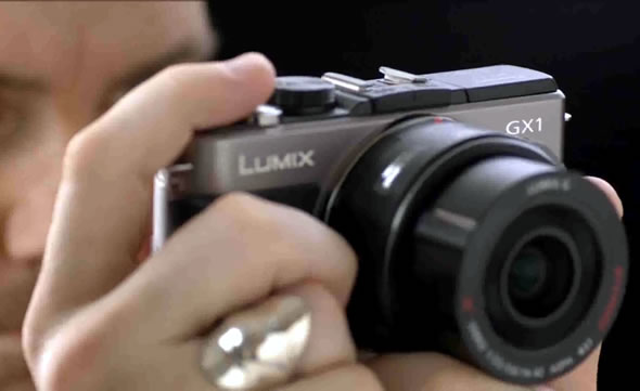 Panasonic Lumix GX1 MFT camera in hand Panasonic Lumix GX1 MFT camera in hand