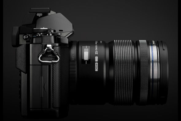 Olympus OM-D E-M5 MFT camera in black side with 12-50mm lens Olympus OM-D E-M5 MFT camera in black side with 12-50mm lens