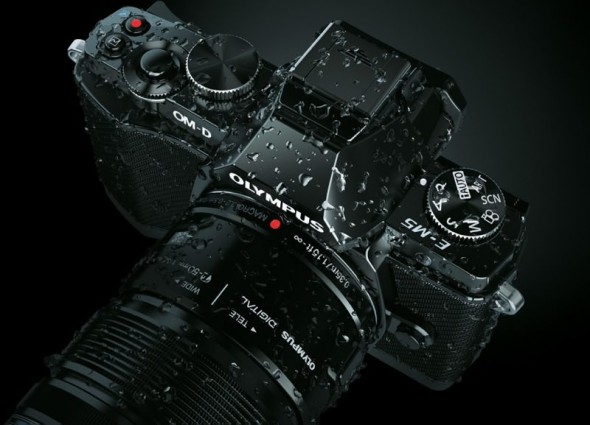 Olympus OM-D E-M5 MFT digital camera wet demonstrating weather-sealing Olympus OM-D E-M5 MFT digital camera wet demonstrating weather-sealing
